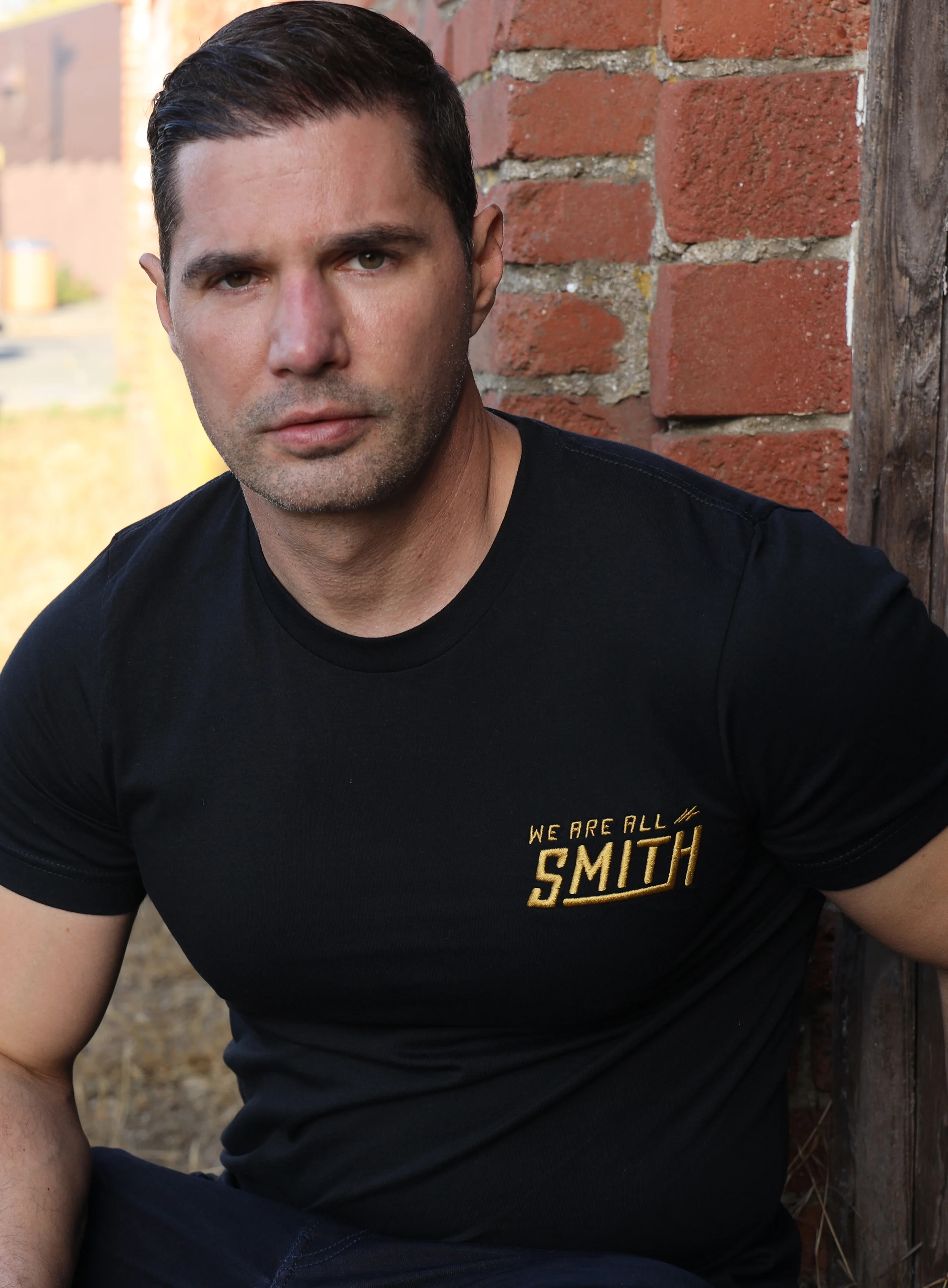 Gold We Are All Smith Embroidered Logo Black Unisex t-shirt - Image 8